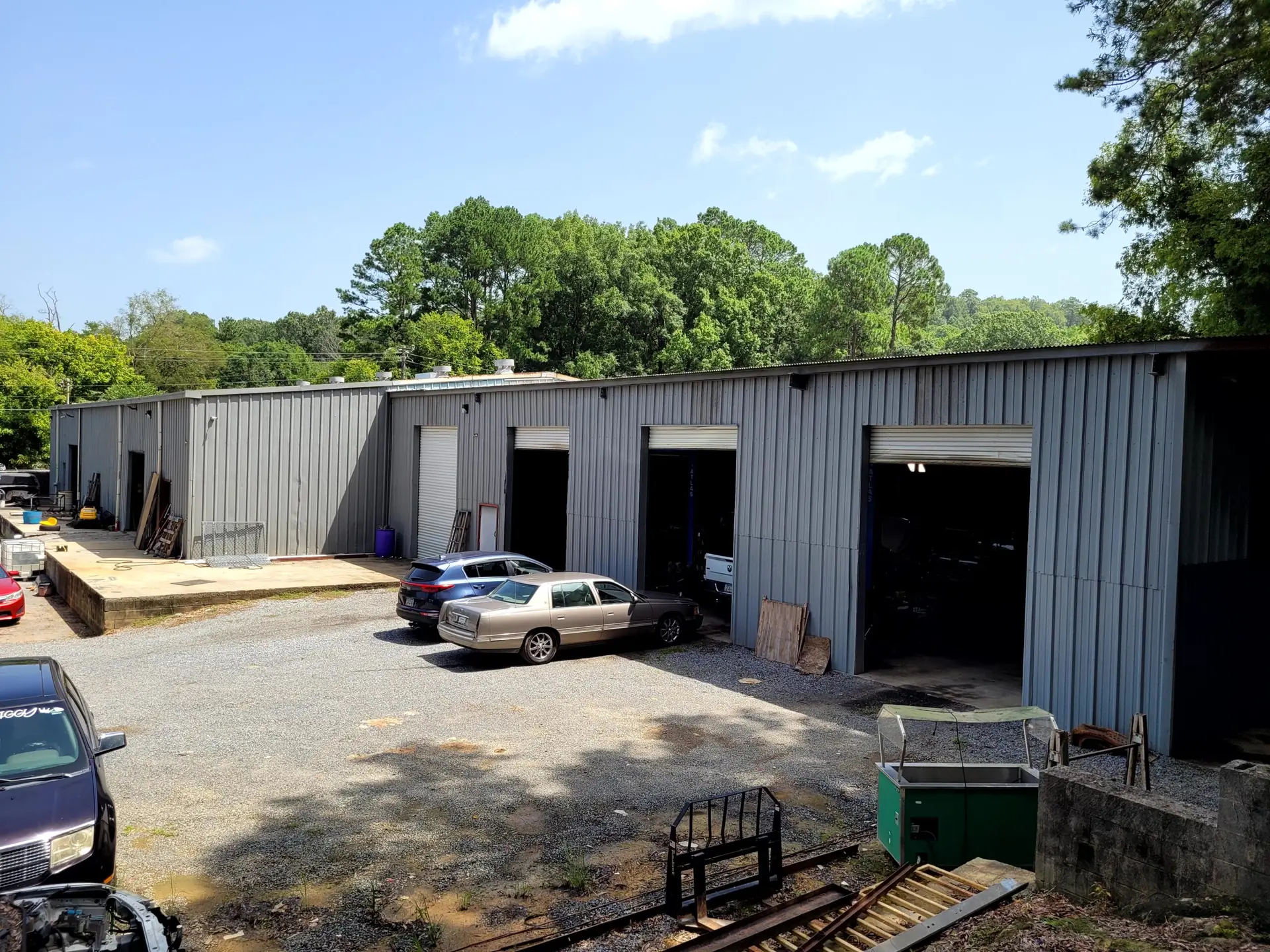 Back view of our automotive facility showing the secure vehicle parking lot.
